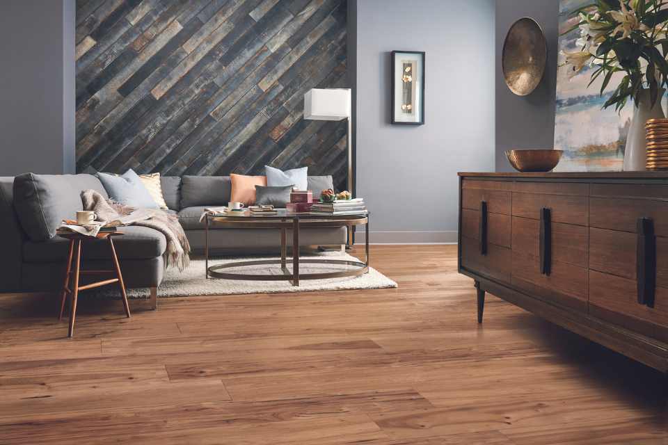 hickory hardwood in living room with gray walls and rustic washed hardwood accent wall.